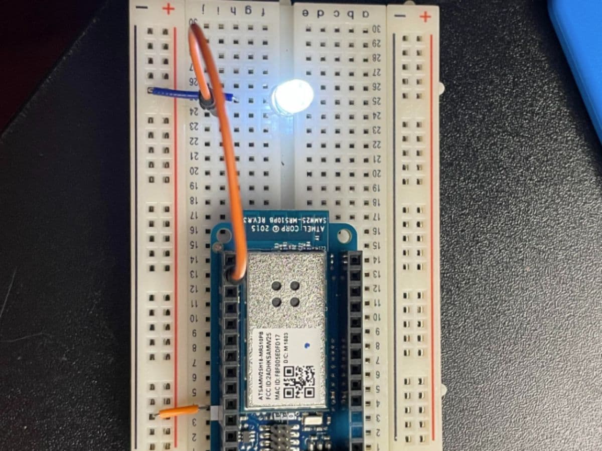 Arduino IoT Bundle board connected with LED indicator lit up