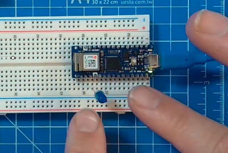 Arduino Nano RP2040 Connect plugged into a breadboard with components wired up