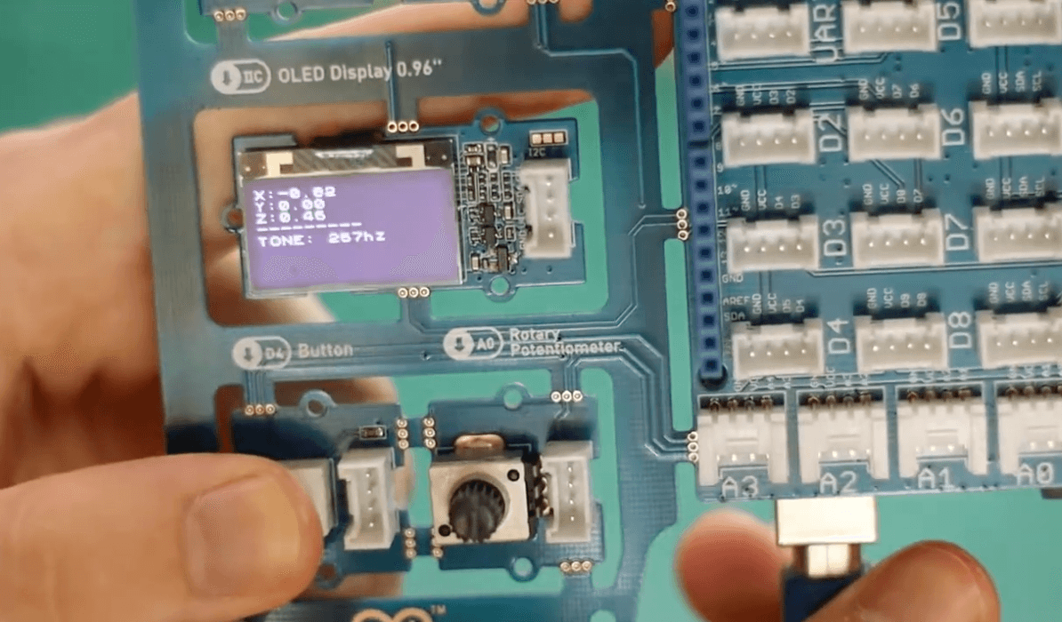 Pressing the button module with the OLED screen displaying output