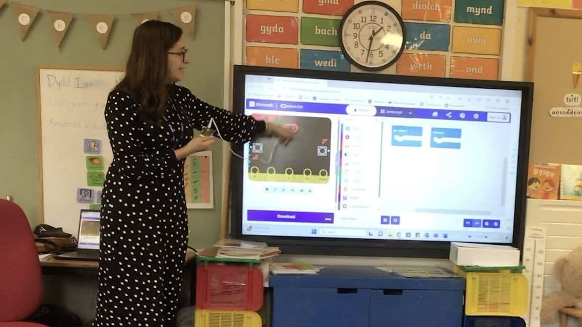 Teacher pointing to a screen during a micro:bit coding lesson