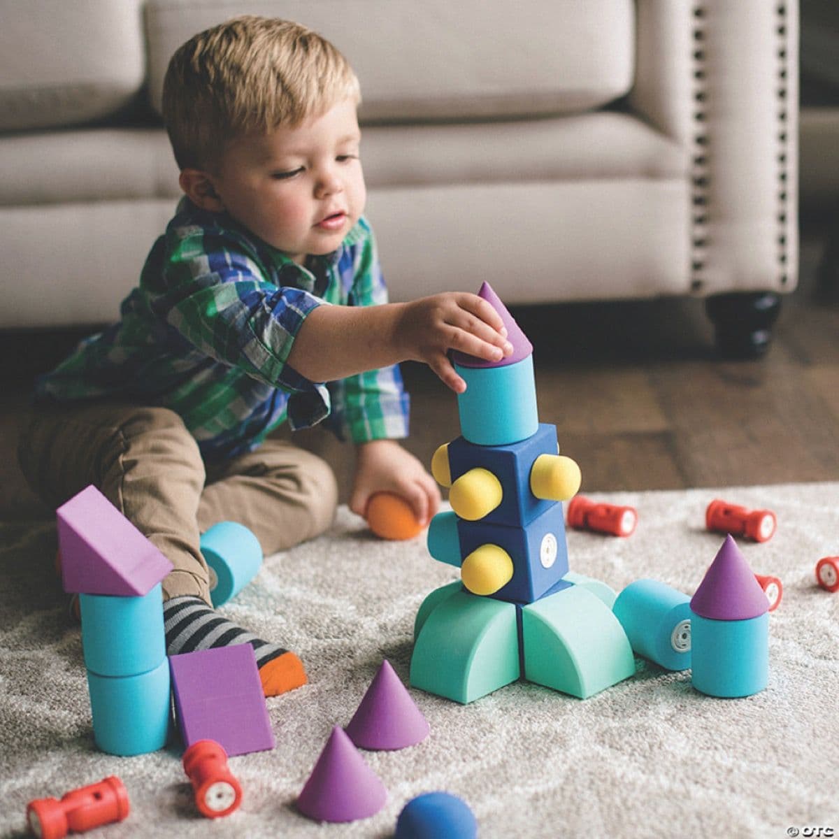 Young boy playing and building with Blockaroo magnetic foam blocks