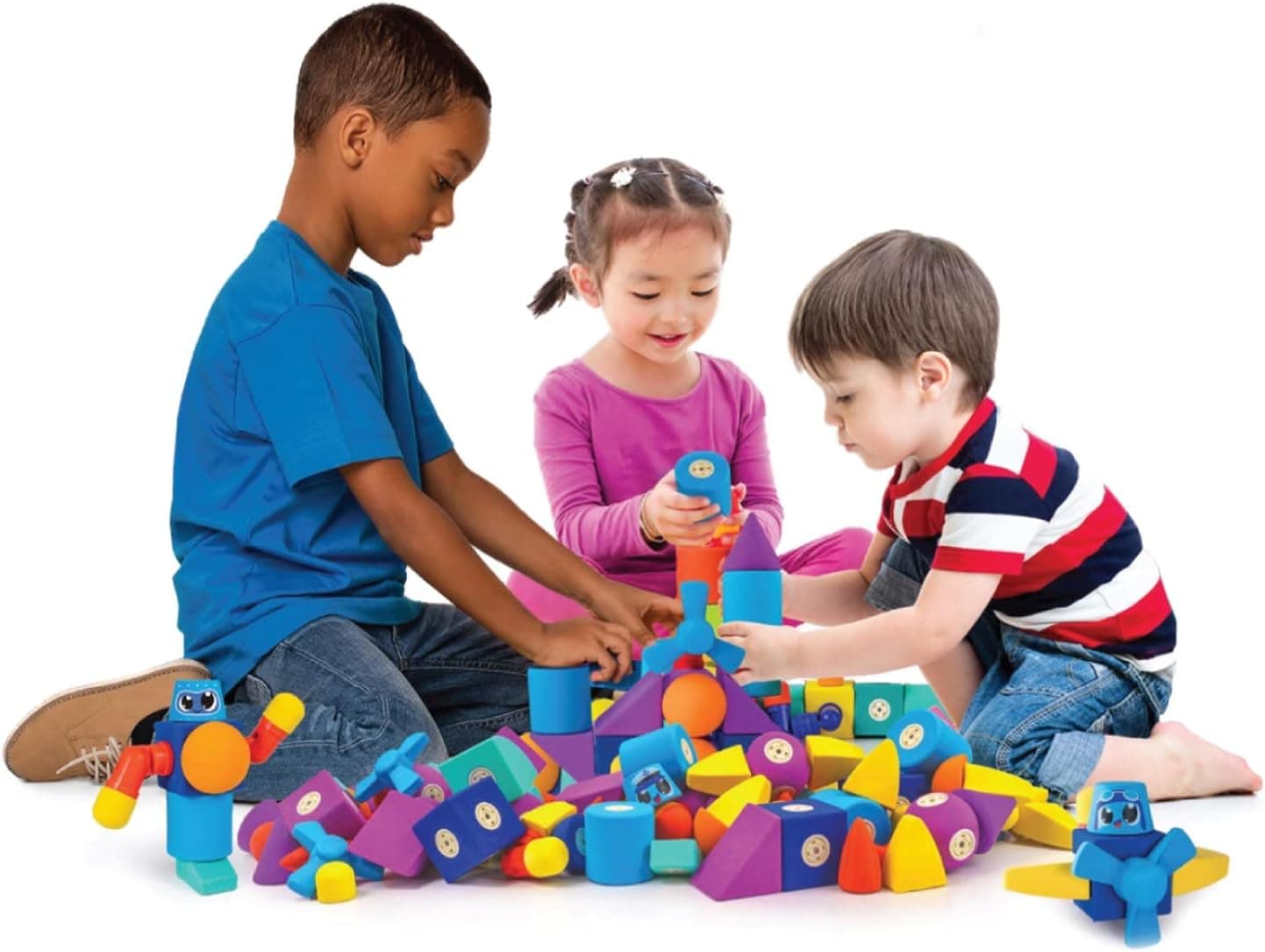 Three children playing with Blockaroo magnetic foam blocks together