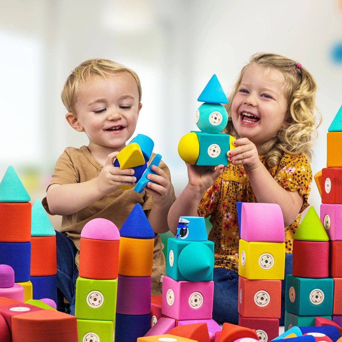 Children laughing and playing with Blockaroo magnetic foam blocks