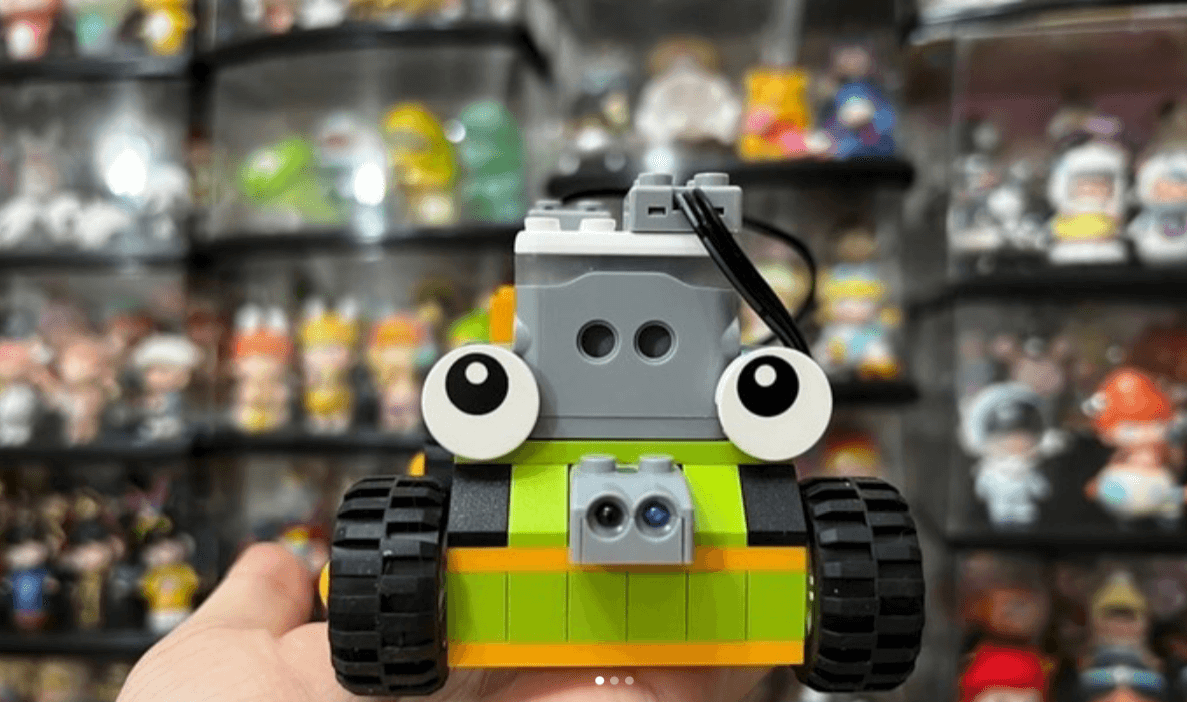 Close-up of hand holding a built Makerzoid car