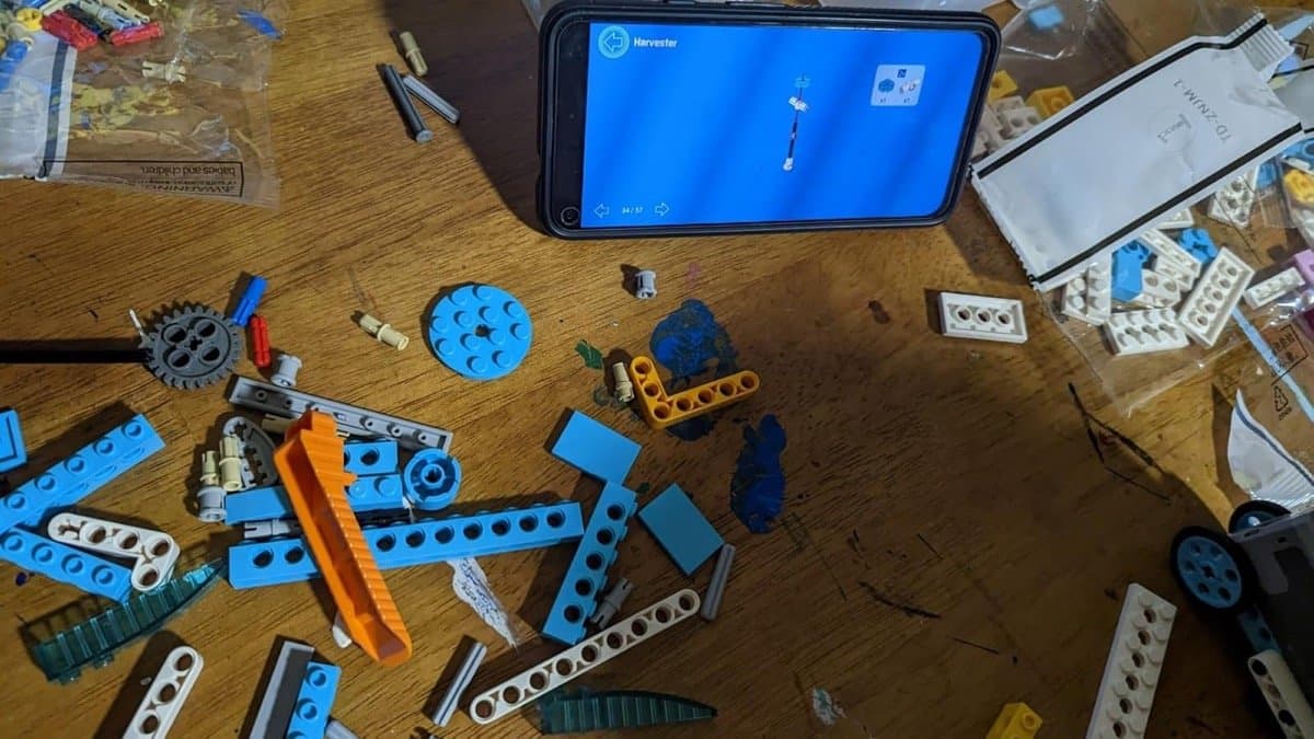 Phone displaying building instructions surrounded by blocks