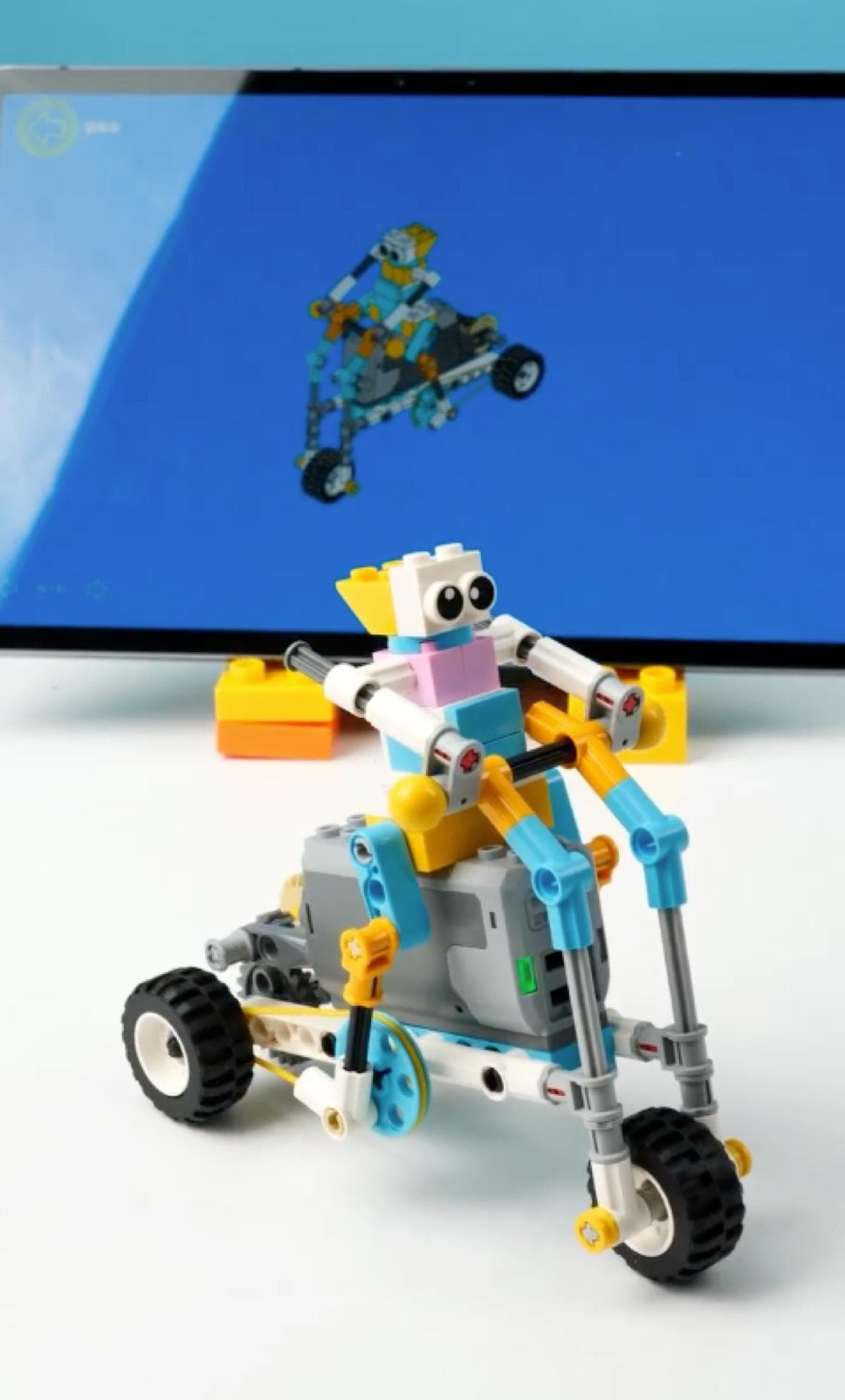 Robot riding bicycle with 3D instruction manual on table