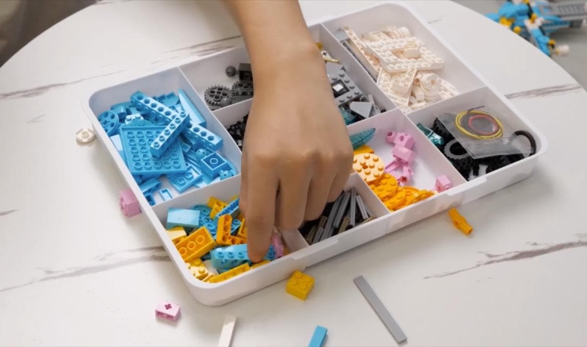 Hands sorting and organising building pieces