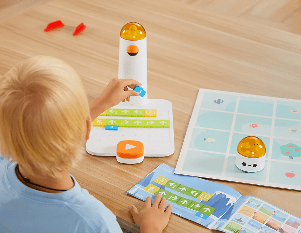 Child independently placing coding blocks on the control board