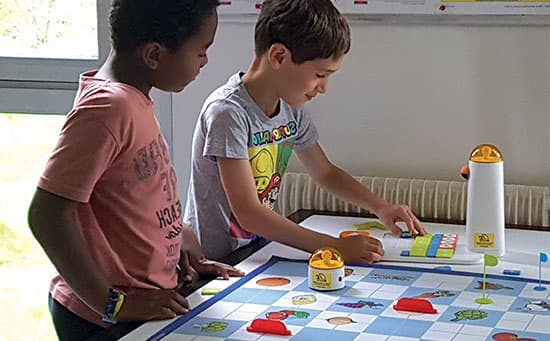 Young boys collaborating on a coding challenge