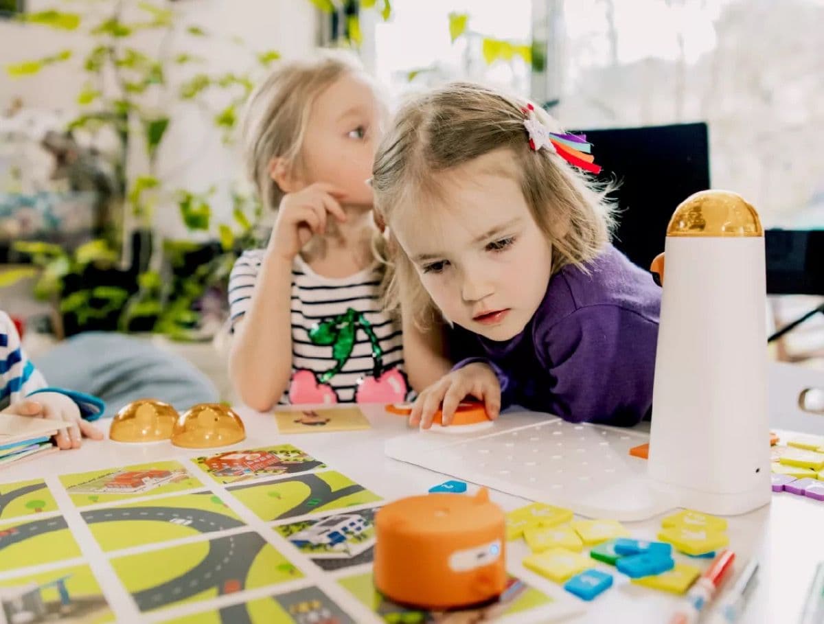 Girl examining coding blocks and planning her programme
