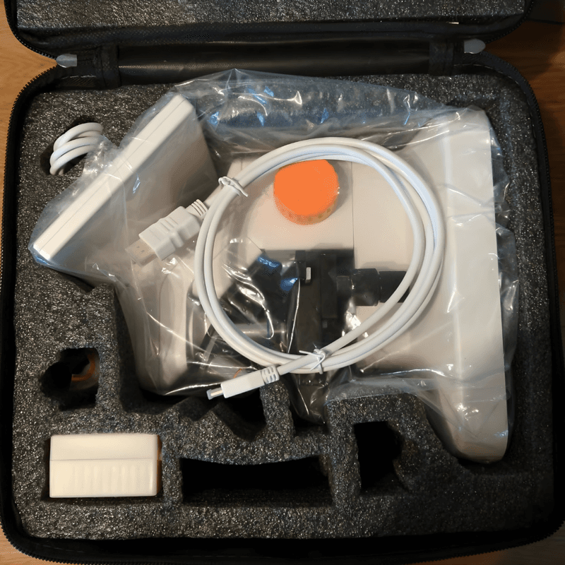 Open box showing the microscope and all included accessories