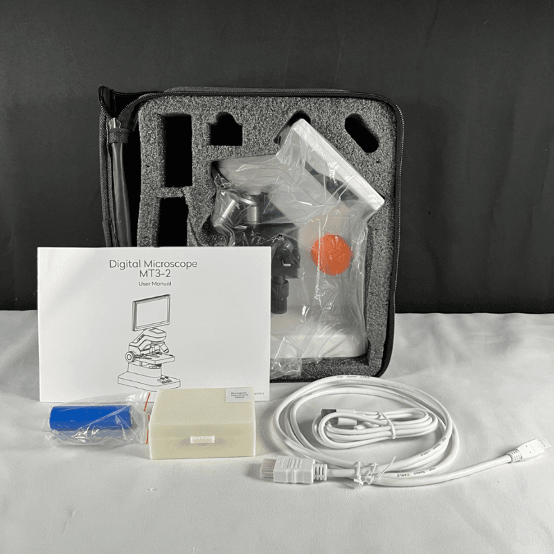 Product packaging open displaying the microscope and components inside