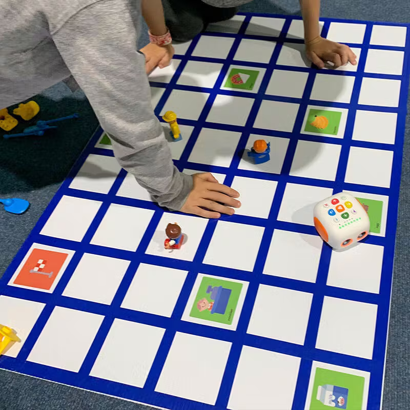 Young children playing with Tale-Bot Pro on interactive board