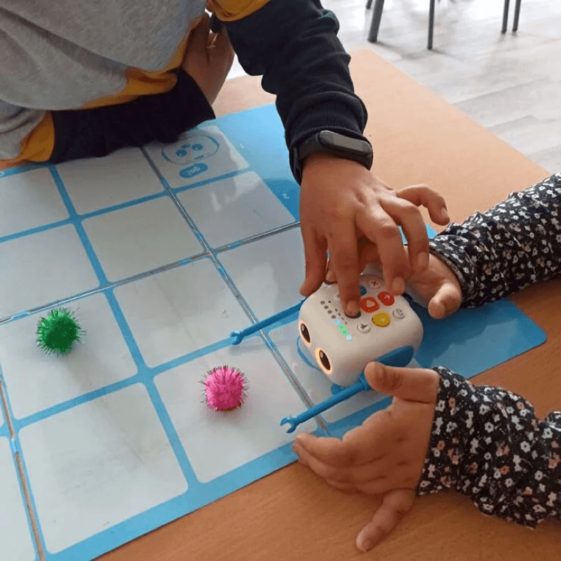 Children coding Tale-Bot Pro with custom arm attachments