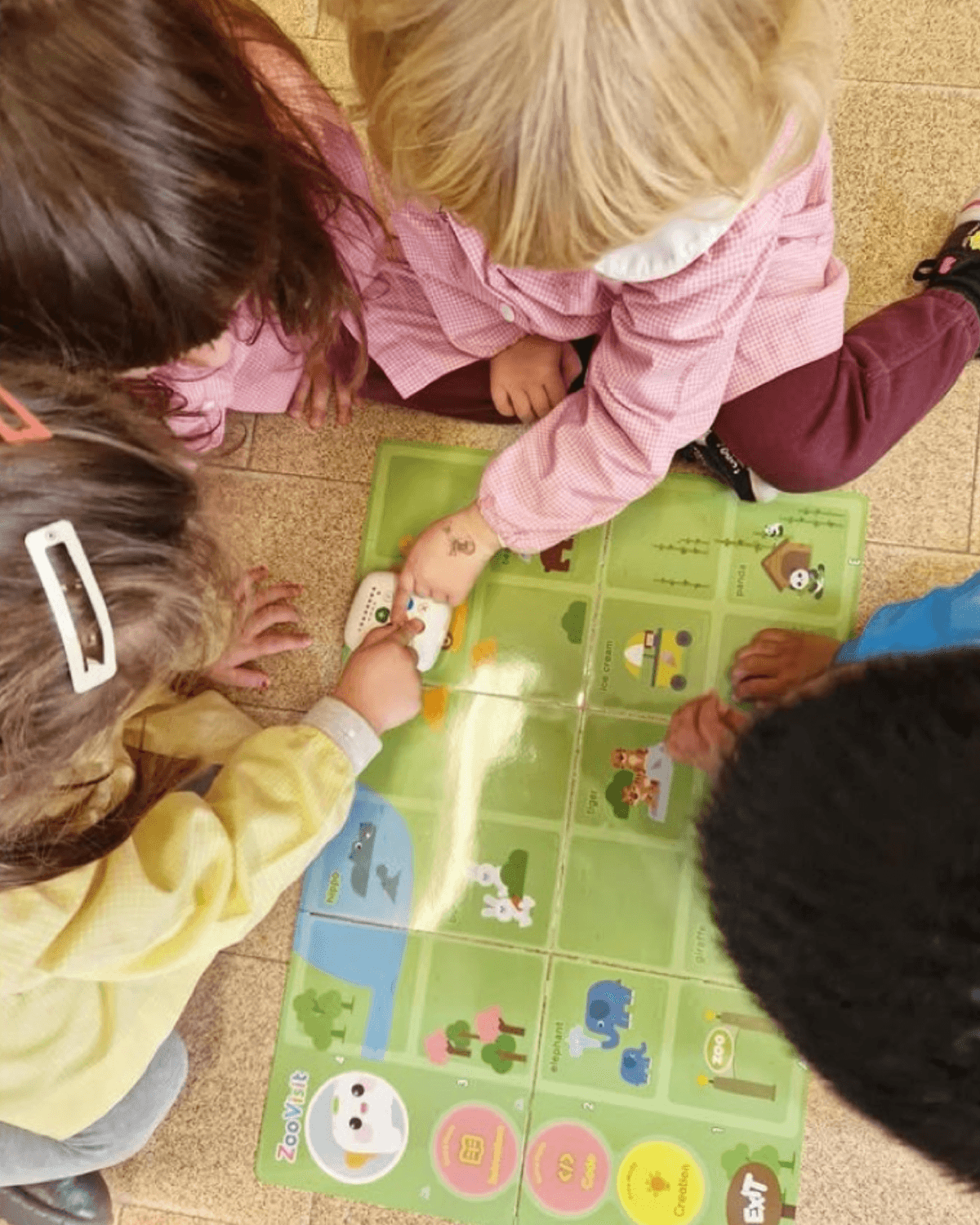Girls pressing command buttons on Tale-Bot Pro robot