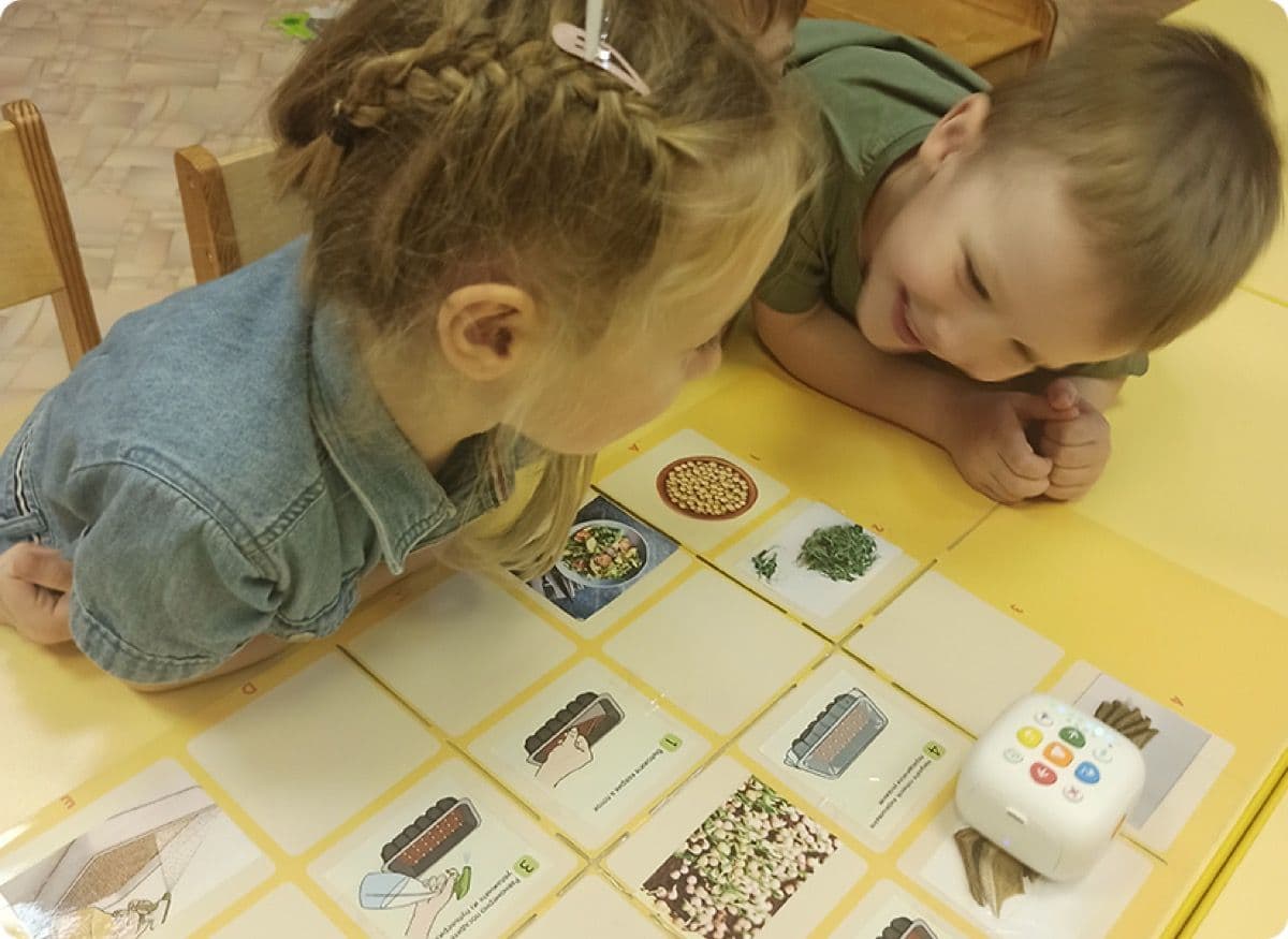 Two young learners coding Tale-Bot Pro through the plant growing interactive map