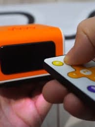 Hand holding VinciBot with IR remote control