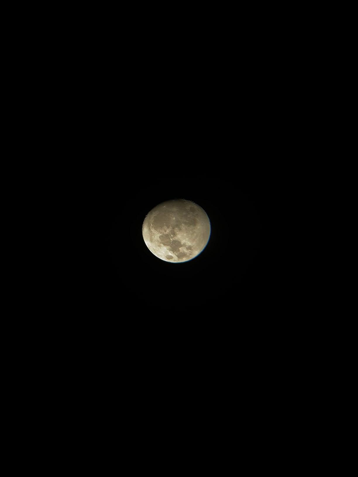 Full moon viewed at lower magnification through the telescope