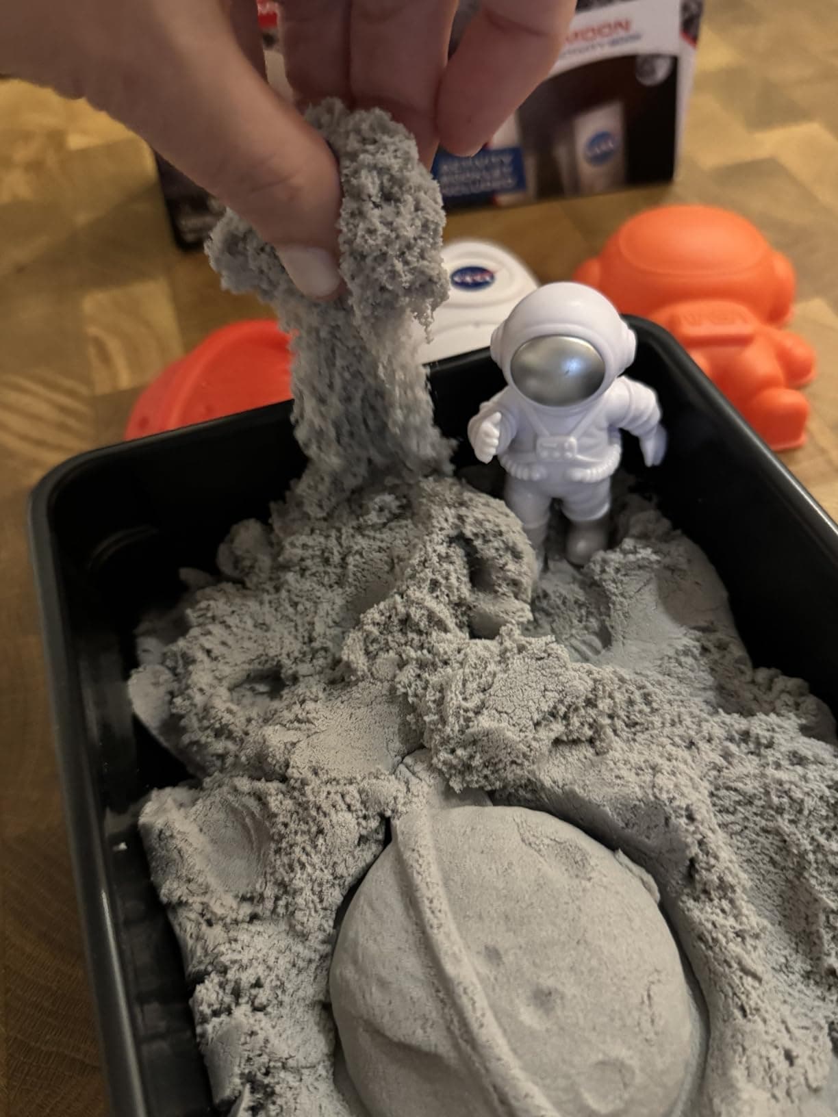 Hand stretching and feeling the moon sand texture
