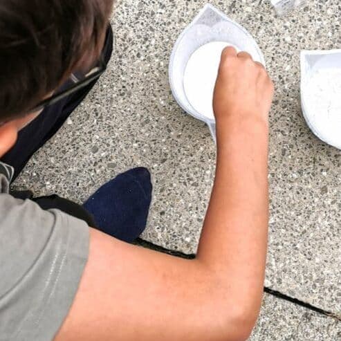 Boy stirring volcano plaster mix
