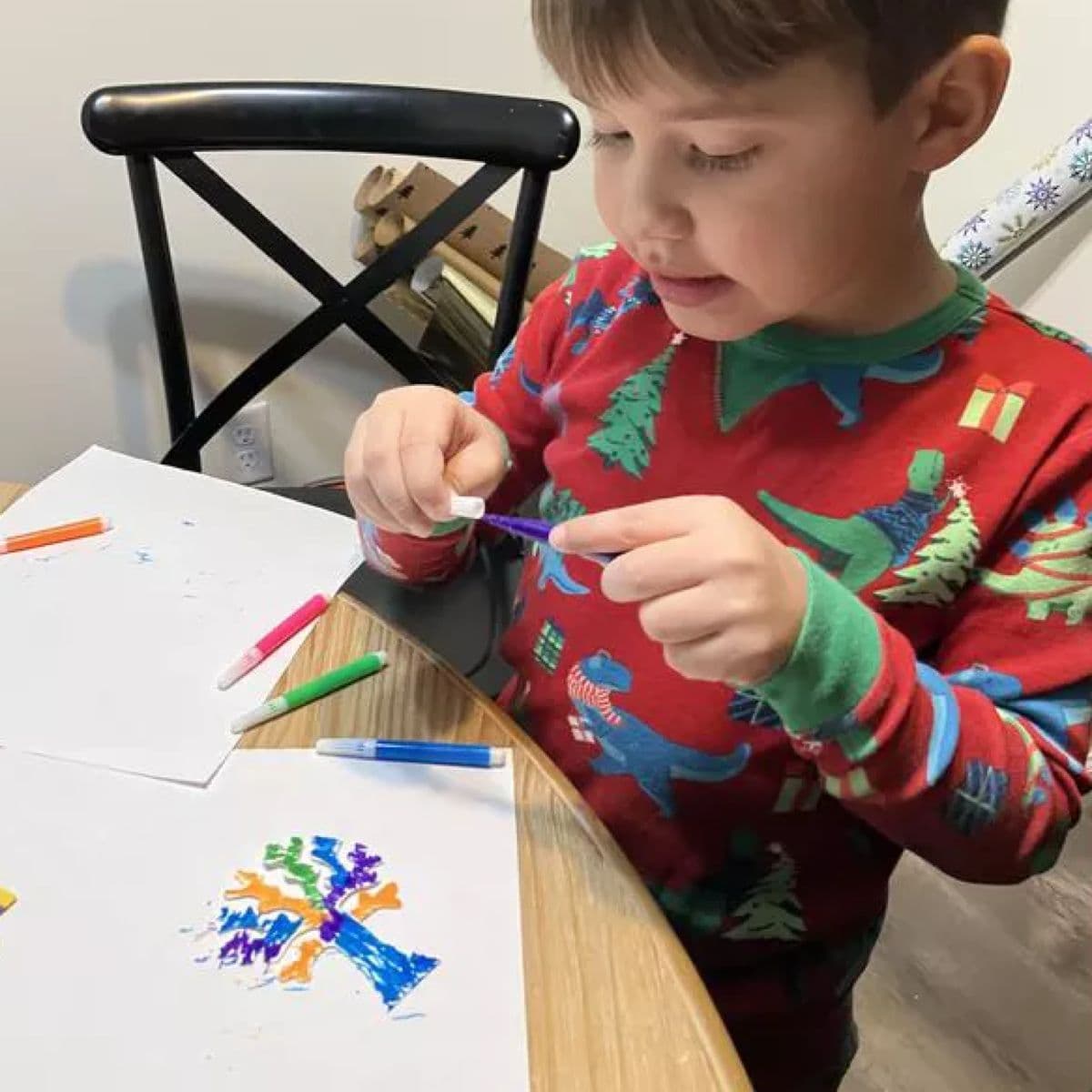 Boy holding a marker, about to colour his crystal tree