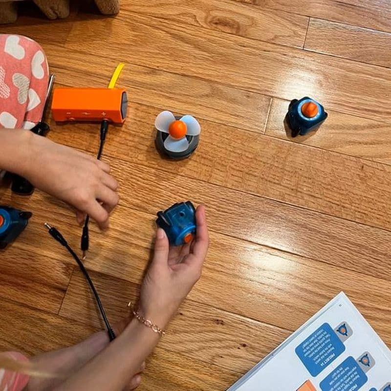 Hands connecting circuit components with snap-in wires