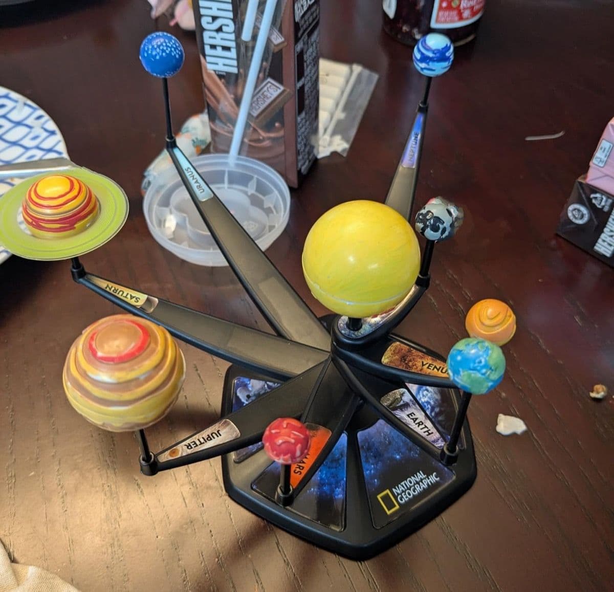 Finished painted solar system model assembled on display arms