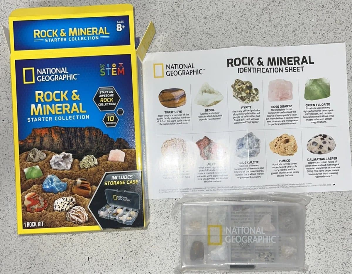 National Geographic Rock and Mineral Starter Collection box opened, showing the identification sheet and acrylic display case