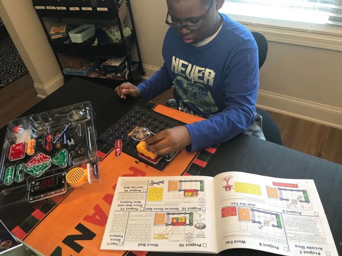Child engaged and playing with the assembled Snap Circuits Arcade