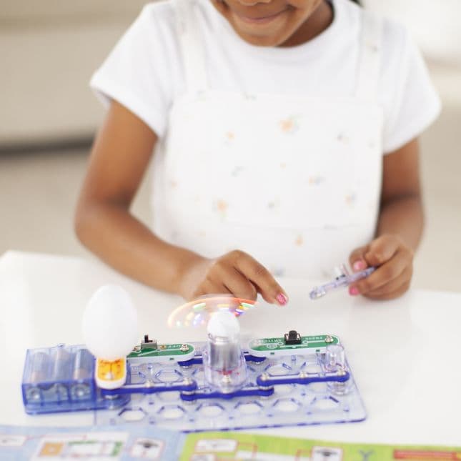 Girl playing with Snap Circuits Beginner kit